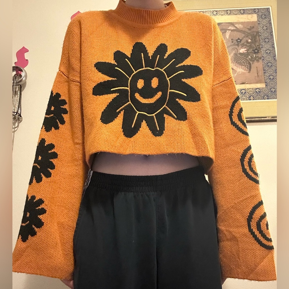 Lazy OafOrange Sweater with Black Sun Design